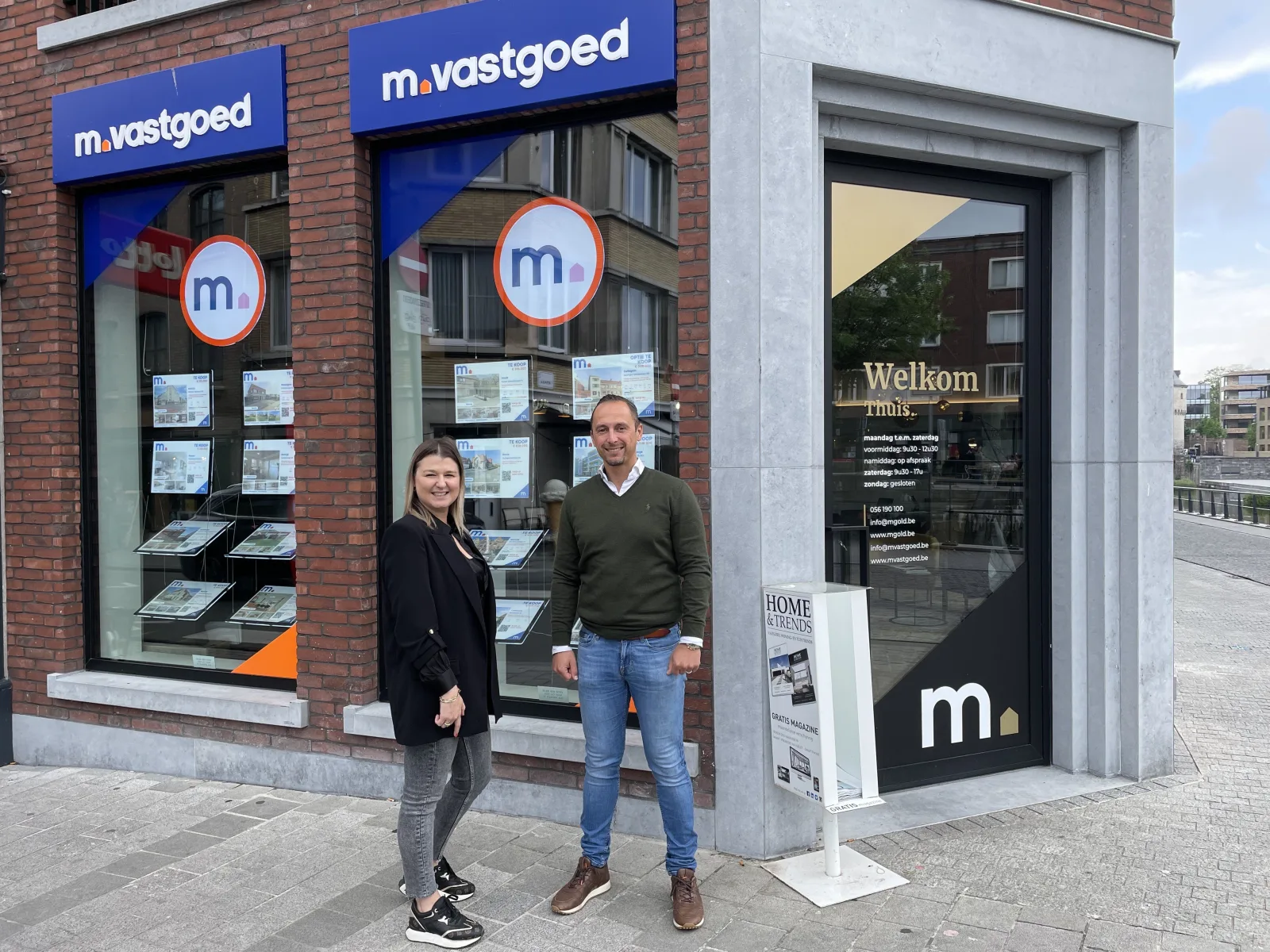 Twee mensen voor het kantoor van M Vastgoed